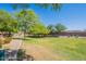 Community greenspace with grass, trees, and landscaping, perfect for outdoor activities at 316 N 78Th Pl, Mesa, AZ 85207