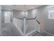Upstairs hallway with carpeted floor and white railing near a window at 316 N 78Th Pl, Mesa, AZ 85207