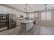 Spacious kitchen featuring white cabinets, granite countertops, a center island, and stainless steel appliances at 316 N 78Th Pl, Mesa, AZ 85207