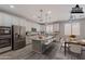 Bright kitchen with stainless steel appliances, a kitchen island with chairs, and tiled floors at 316 N 78Th Pl, Mesa, AZ 85207