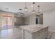 Stylish kitchen featuring a spacious island, modern lighting, and an open layout leading to the dining area at 316 N 78Th Pl, Mesa, AZ 85207
