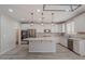 Bright kitchen with a large center island, stainless steel appliances, and modern pendant lighting at 316 N 78Th Pl, Mesa, AZ 85207