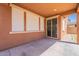 Covered patio with privacy window coverings and access to the home via sliding glass doors at 316 N 78Th Pl, Mesa, AZ 85207