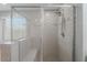 This bathroom features a tiled shower with a built-in seat and glass doors at 316 N 78Th Pl, Mesa, AZ 85207