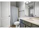 Clean bathroom featuring vanity sink with a white countertop, a toilet, and a shower with a patterned curtain at 32819 N 23Rd Ave, Phoenix, AZ 85085