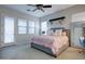 Bedroom with large windows, a cozy bed, a ceiling fan, and outdoor access at 32819 N 23Rd Ave, Phoenix, AZ 85085