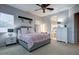 Comfortable bedroom featuring a ceiling fan, nightstands, and ensuite bathroom access at 32819 N 23Rd Ave, Phoenix, AZ 85085