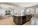 Open kitchen with island and granite countertops overlooks cozy living area at 32819 N 23Rd Ave, Phoenix, AZ 85085