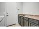 Laundry room featuring a washing machine, sink and cabinet with a dark countertop at 32819 N 23Rd Ave, Phoenix, AZ 85085