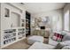 Cozy living room with built-in shelving, modern artwork, and comfortable seating near a window at 32819 N 23Rd Ave, Phoenix, AZ 85085