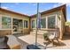 Cozy backyard patio with comfortable seating, an umbrella, and lush landscaping at 32819 N 23Rd Ave, Phoenix, AZ 85085