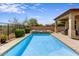 Sparkling pool with waterfall feature and landscaped backyard, perfect for relaxing or entertaining at 32819 N 23Rd Ave, Phoenix, AZ 85085