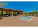 Outdoor pool area with covered seating, dining tables, and lounge chairs at 32819 N 23Rd Ave, Phoenix, AZ 85085