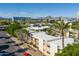 An aerial view of an apartment building with palm trees and mountain views in the background on a sunny day at 3655 N 5Th Ave # 202, Phoenix, AZ 85013