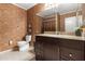 Stylish bathroom featuring elegant vanity with granite countertop, decorative wallpaper, and updated fixtures at 3655 N 5Th Ave # 202, Phoenix, AZ 85013