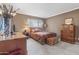 Cozy bedroom featuring neutral walls, a comfortable bed, and classic wood furnishings at 3655 N 5Th Ave # 202, Phoenix, AZ 85013