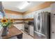 Well-lit kitchen with stainless steel appliances, white cabinets, and a neutral backsplash for easy cooking at 3655 N 5Th Ave # 202, Phoenix, AZ 85013
