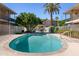 Beautiful community pool with lounge chairs, patio table and lush landscaping at a charming, well-maintained property at 3655 N 5Th Ave # 202, Phoenix, AZ 85013