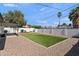 Spacious backyard featuring a lush lawn, a patio, a grill, and a sturdy privacy fence at 3837 E Yale St, Phoenix, AZ 85008