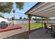 Wide angle shows patio, grill deck, artificial grass, desert landscaping and privacy fence at 3837 E Yale St, Phoenix, AZ 85008