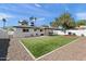 Expansive backyard featuring a lush lawn, a covered patio, a grill, a storage shed and a privacy fence at 3837 E Yale St, Phoenix, AZ 85008