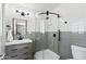 Elegant bathroom with sleek black fixtures, a modern vanity, and a glass-enclosed shower for a spa-like experience at 3837 E Yale St, Phoenix, AZ 85008