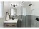 Stylish bathroom showcasing a glass-enclosed shower, modern vanity, and sleek black fixtures for a contemporary feel at 3837 E Yale St, Phoenix, AZ 85008
