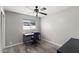A well-lit bedroom features a desk area, neutral walls, carpeted floors, and a window for natural light at 3837 E Yale St, Phoenix, AZ 85008