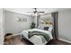 Bright bedroom features hardwood floors, a ceiling fan, and two windows offering natural light at 3837 E Yale St, Phoenix, AZ 85008