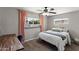 Cozy bedroom with neutral walls, carpeted floors, and a large window with views of the outdoors at 3837 E Yale St, Phoenix, AZ 85008
