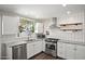 Modern kitchen equipped with stainless steel appliances, granite countertops, and white subway tile backsplash at 3837 E Yale St, Phoenix, AZ 85008