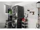 Updated laundry room with front loading washer and dryer and organized wall storage at 3837 E Yale St, Phoenix, AZ 85008