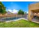 Lush backyard featuring a swimming pool, green lawn, and an orange tree at 4341 E Abraham Ln, Phoenix, AZ 85050