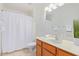 Clean bathroom features a single sink vanity and a shower-tub combo with white shower curtain at 4341 E Abraham Ln, Phoenix, AZ 85050