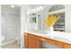 Bright bathroom with wooden vanity, large mirror, and walk-in shower at 4341 E Abraham Ln, Phoenix, AZ 85050