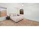 Bright bedroom with neutral walls, carpeted floors, a bed, and two windows allowing ample natural light at 4341 E Abraham Ln, Phoenix, AZ 85050