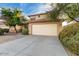 Beige two story home with a two car garage and low maintenance landscaping at 4341 E Abraham Ln, Phoenix, AZ 85050