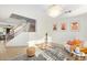 Open living room with staircase, stylish decor, and bright, natural light at 4341 E Abraham Ln, Phoenix, AZ 85050