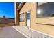 Stucco wall with door on outdoor patio with an orange on the ground at 4341 E Abraham Ln, Phoenix, AZ 85050