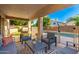 Covered patio featuring comfortable seating, outdoor rug, and view of the pool and backyard at 4341 E Abraham Ln, Phoenix, AZ 85050