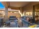 Covered outdoor patio featuring comfortable seating, outdoor rug, and access to the backyard through a sliding glass door at 4341 E Abraham Ln, Phoenix, AZ 85050