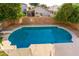 Backyard with a diving board, refreshing swimming pool surrounded by trees filled with ripe oranges at 4341 E Abraham Ln, Phoenix, AZ 85050