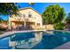 Backyard with a refreshing swimming pool surrounded by a fence and lush landscaping with a view of the home at 4341 E Abraham Ln, Phoenix, AZ 85050