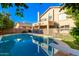 Inviting backyard pool with diving board and secure safety fence, perfect for outdoor relaxation and entertaining at 4341 E Abraham Ln, Phoenix, AZ 85050