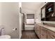 Comfortable bathroom including tub, walk-in shower, and large vanity at 43803 W Wade Dr, Maricopa, AZ 85138