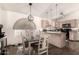Charming dining area with stylish chandelier and a view into the kitchen, perfect for Gathering meals at 43803 W Wade Dr, Maricopa, AZ 85138