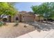 Single-story home featuring desert landscaping, a two-car garage, and neutral stucco facade at 43803 W Wade Dr, Maricopa, AZ 85138