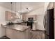 This kitchen offers a functional island with mosaic countertop and stylish cabinetry at 43803 W Wade Dr, Maricopa, AZ 85138