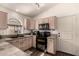 Well-lit kitchen featuring built-in appliances and mosaic countertops at 43803 W Wade Dr, Maricopa, AZ 85138