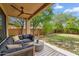 Inviting covered patio with ceiling fan and comfortable seating area in landscaped backyard at 4430 E Creosote Dr, Cave Creek, AZ 85331